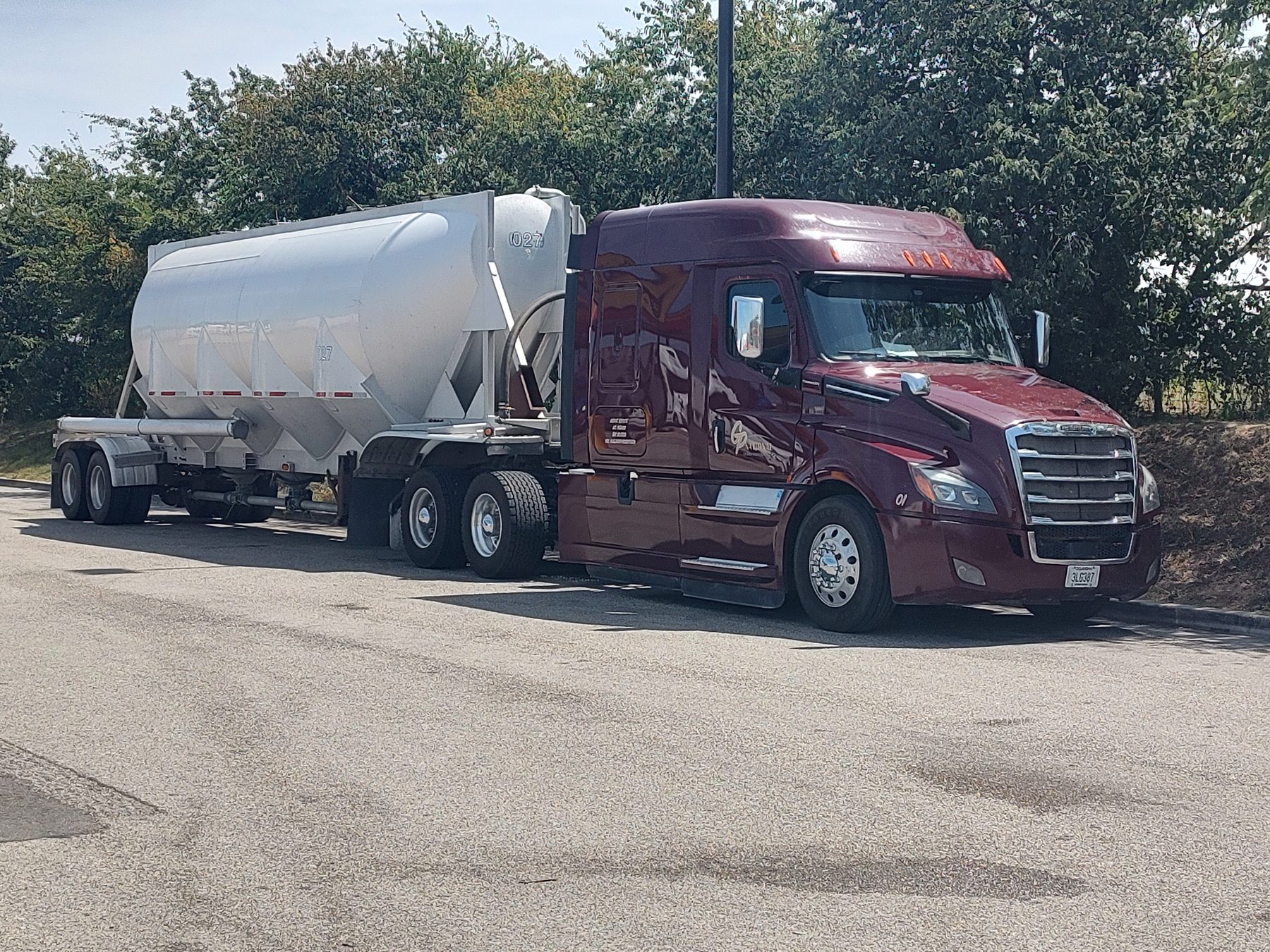 GP National tractor and white pneumatic bulk trailer parked, wide view